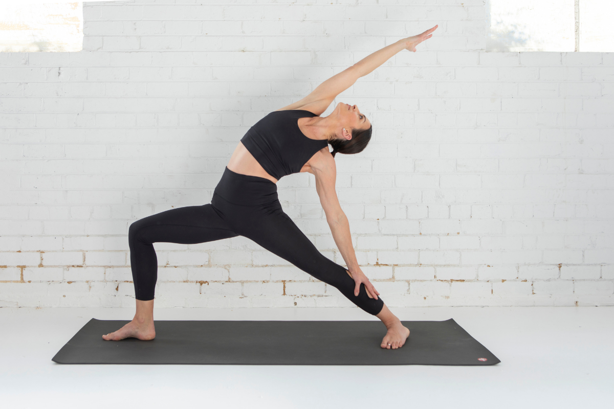women on yoga mat stretching backwards