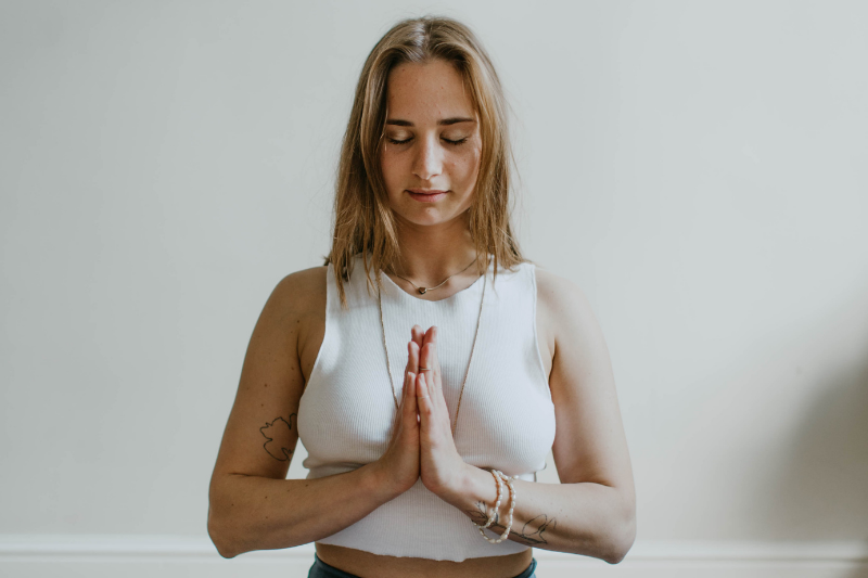 woman in meditating pose, hands together