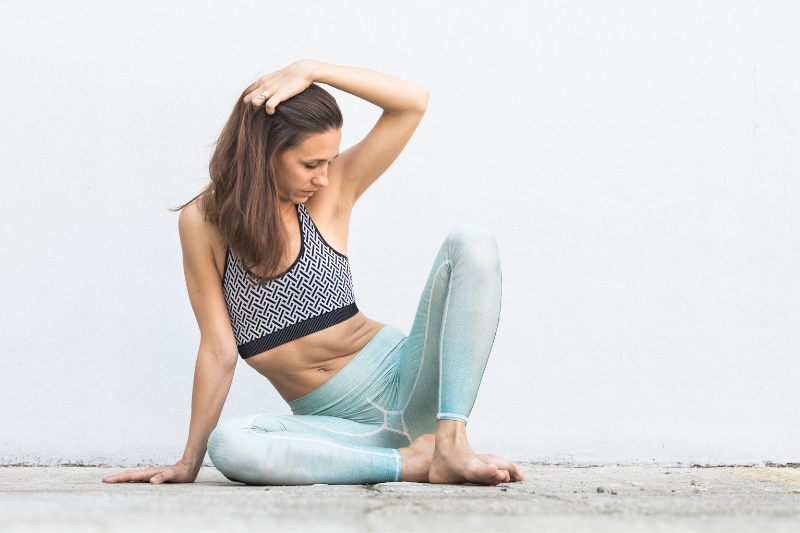 Female sitting on yoga mat