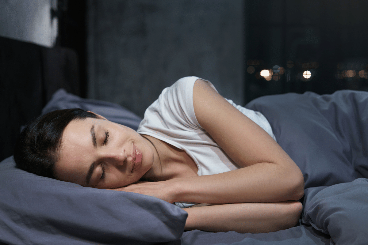 woman sleeping in bed on her side