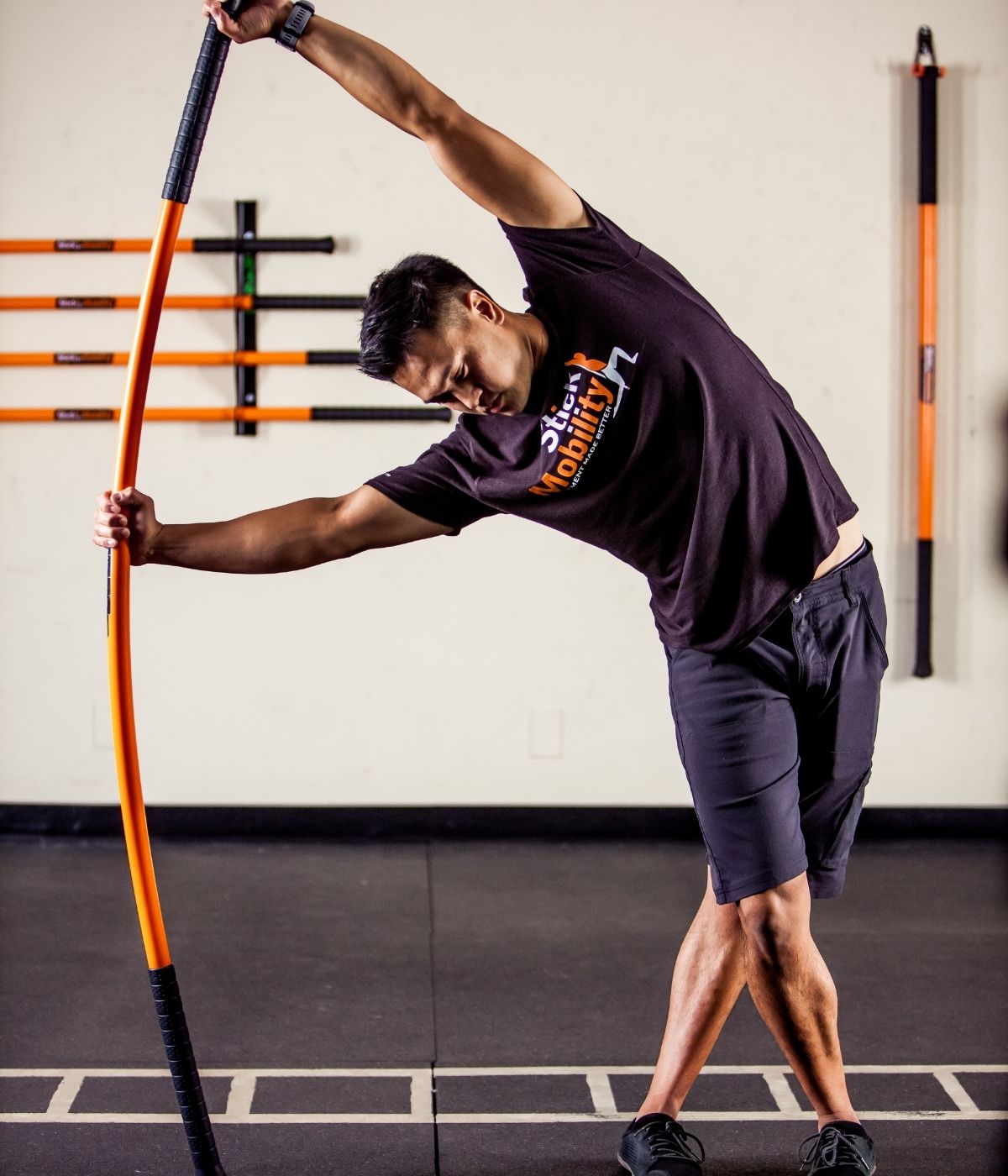 Stick Mobility demonstrated by man in gym