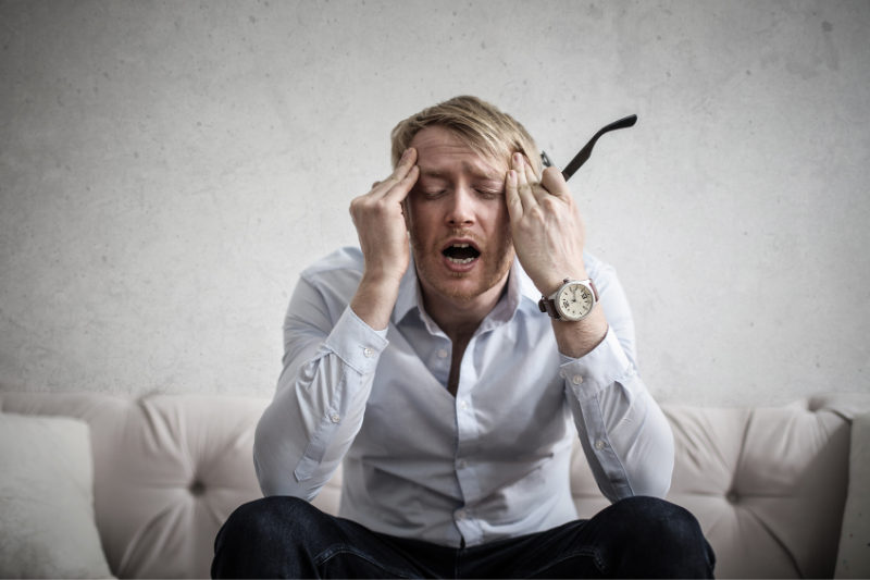 Man stressed on couch