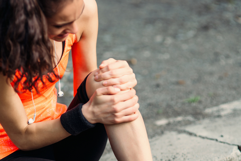 Woman injured holding knee