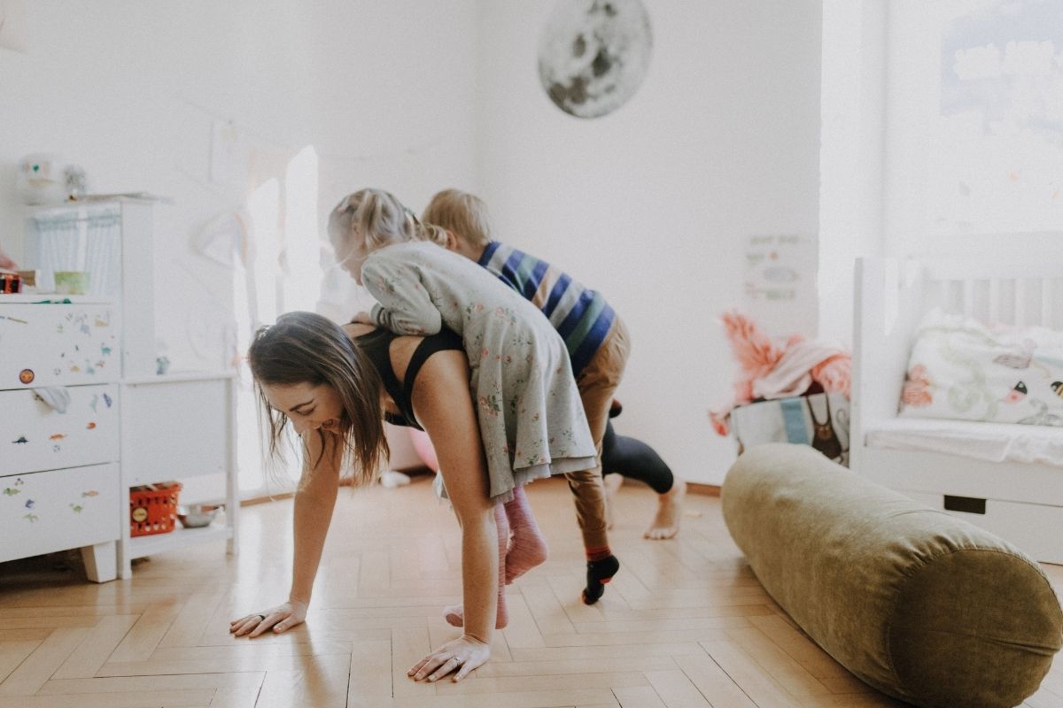 Woman doing exercise with kids on her