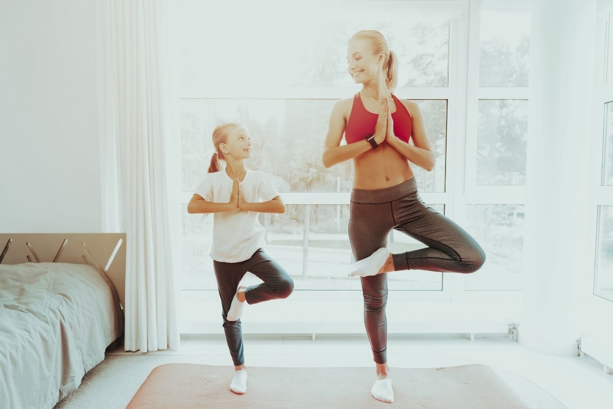 Mother and daughter doing yoga